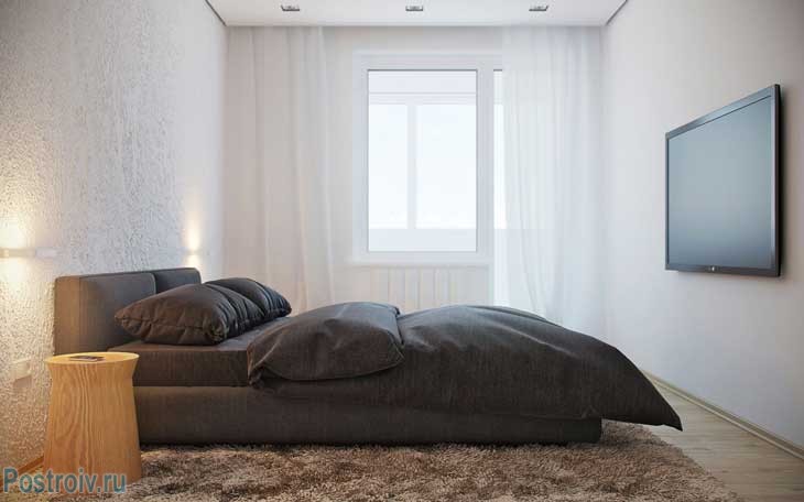 Стиль минимализм в интерьере спальни. Белоснежные стены и черный текстиль. Фото